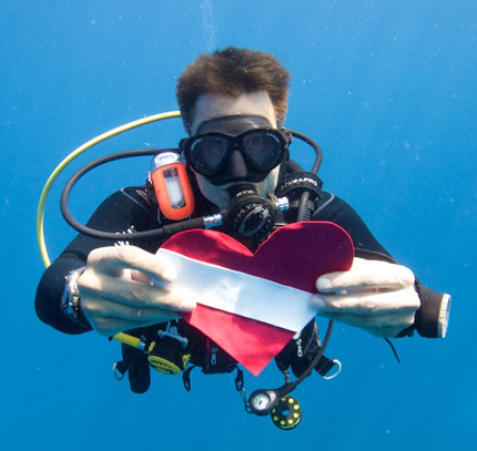 image of a diver holding a heart